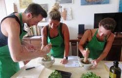 Pounding basil leaves for making pesto